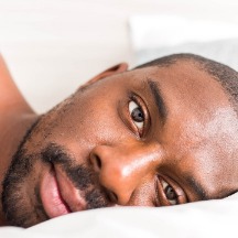 single male with head on a pillow